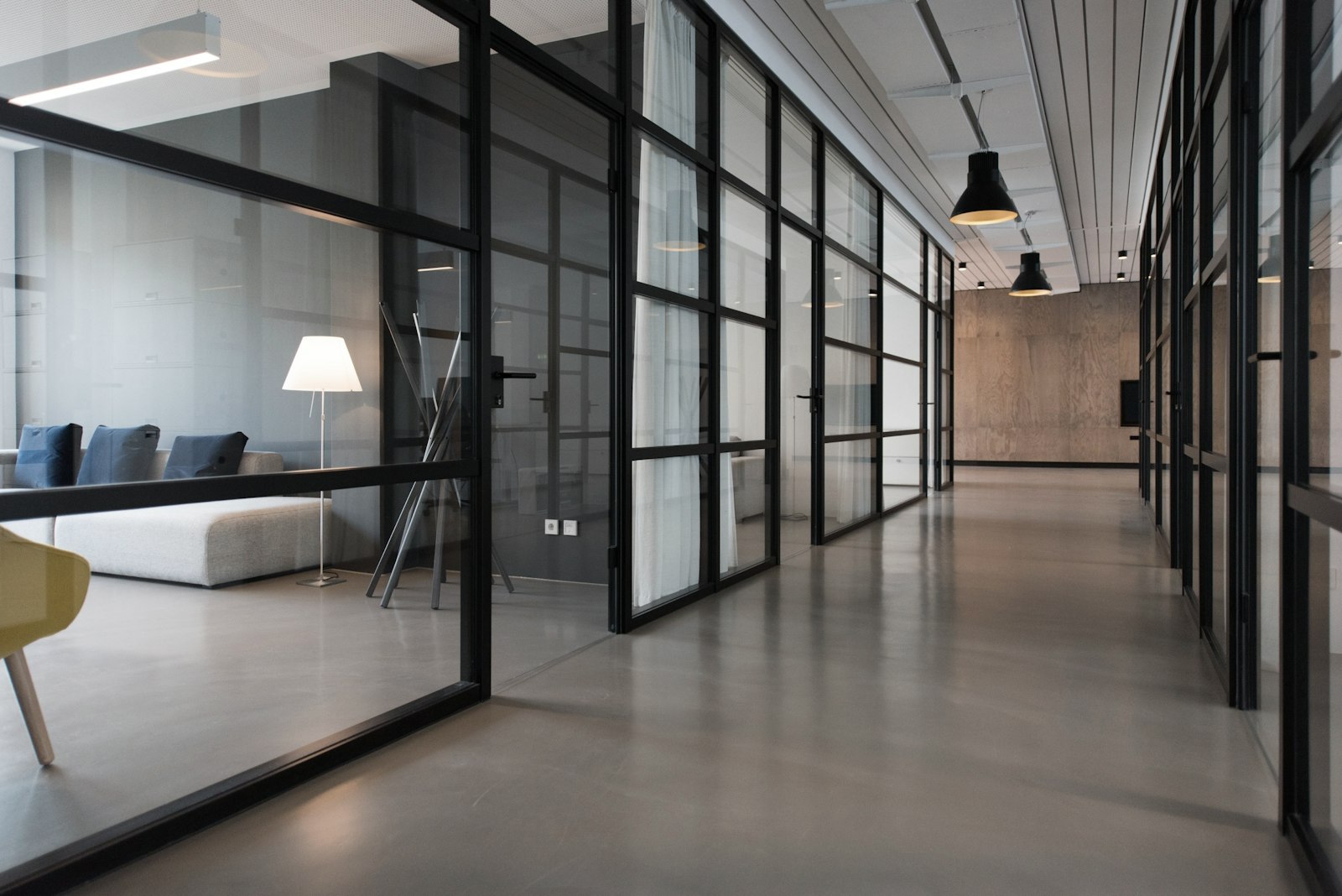 Modern office interior with concrete floors and glass partitions
